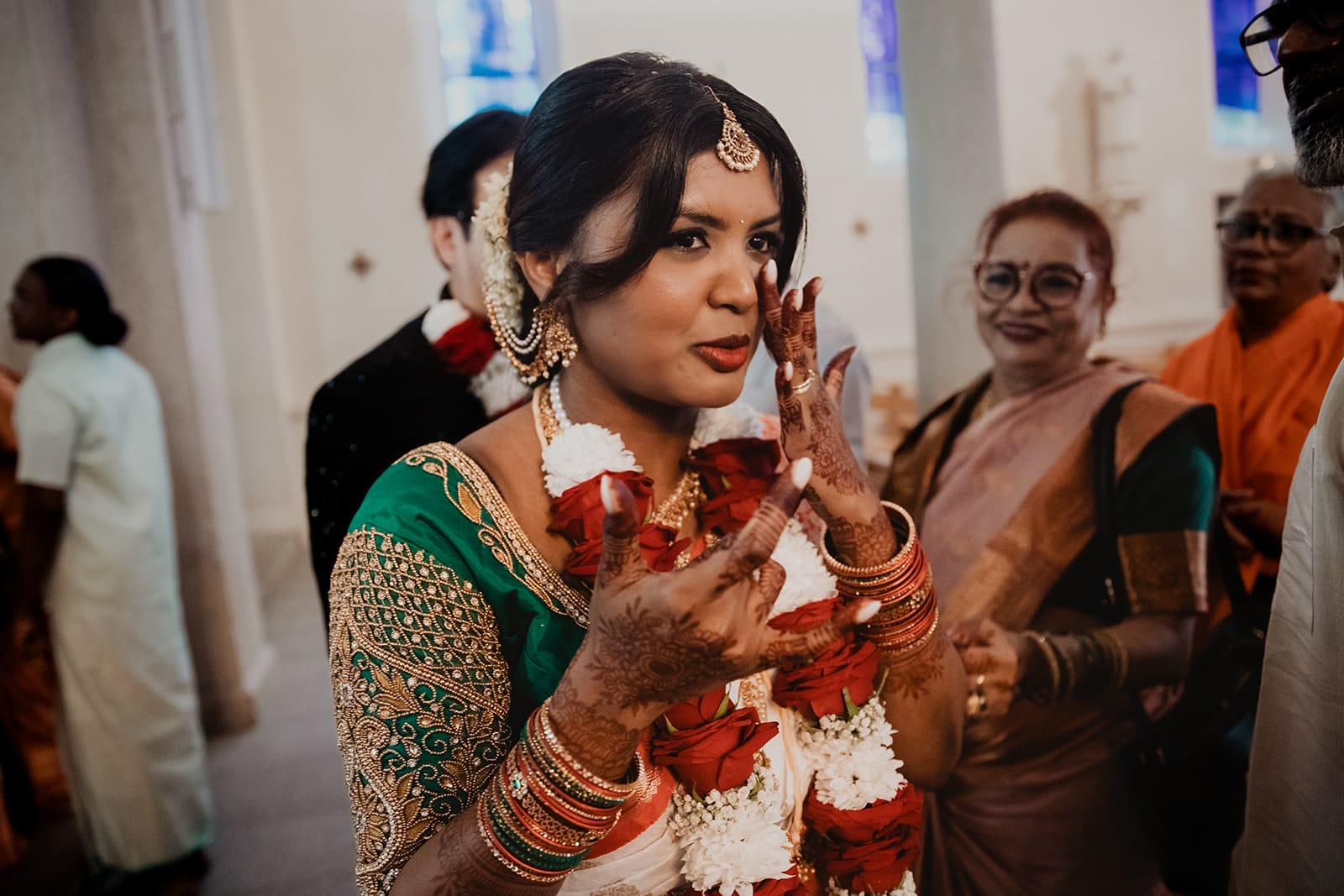 Mariée émue avec ses mains décorées de henné pendant une cérémonie de mariage